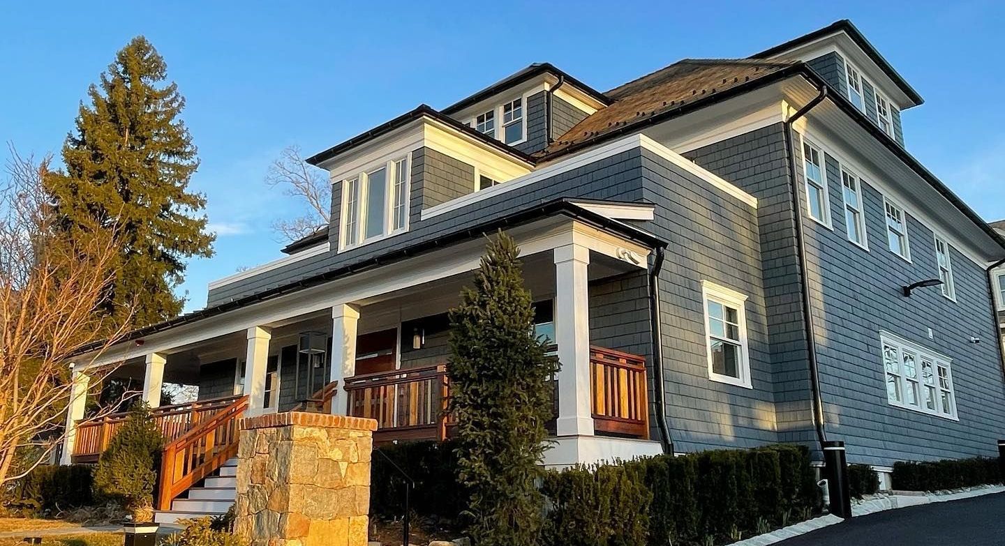 A large house with a large porch and stairs