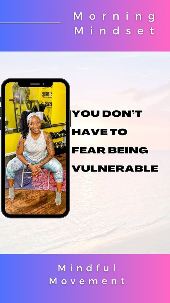 A woman is sitting on a chair in front of a cell phone.
