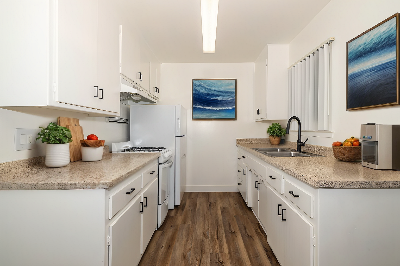 Bright kitchen with white cabinets, granite counters, wood floors, and blue wall art.