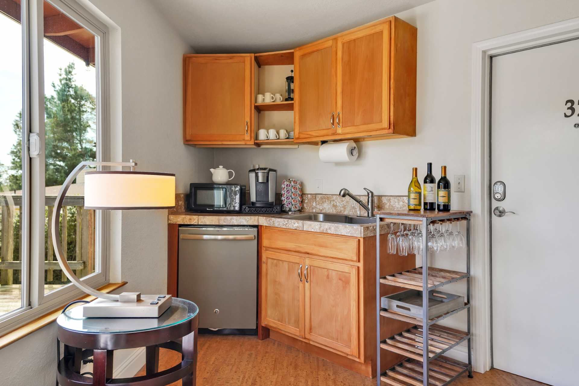 A small kitchen with wooden cabinets and a wine rack