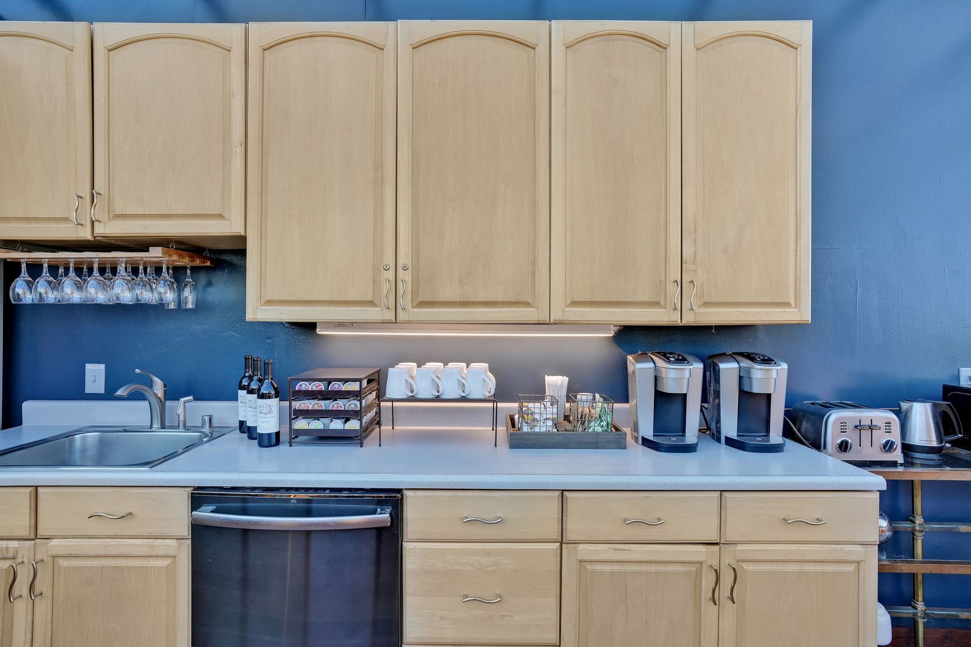 A kitchen with wooden cabinets and stainless steel appliances
