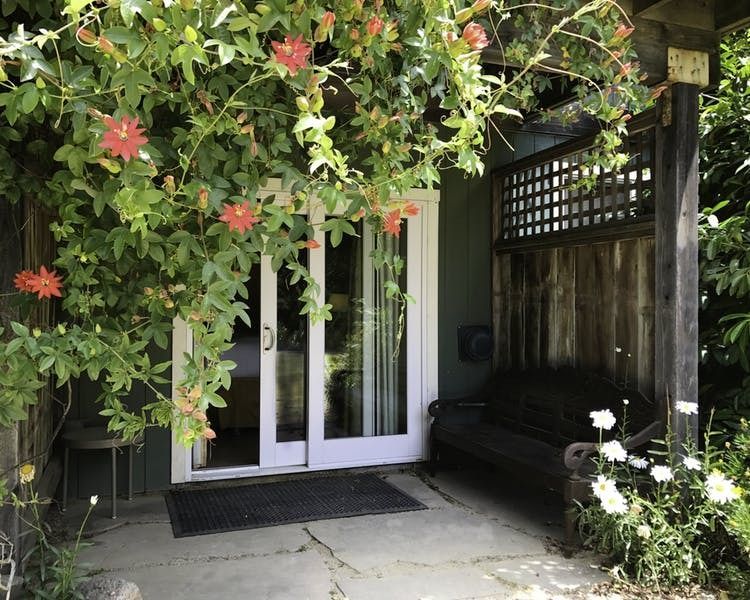 A house with a sliding glass door and a bench in front of it