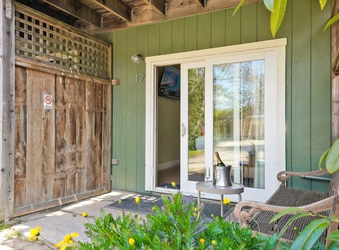 A green house with a white sliding glass door