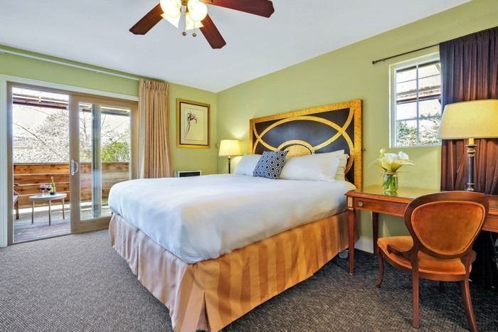 A hotel room with a king size bed and a desk