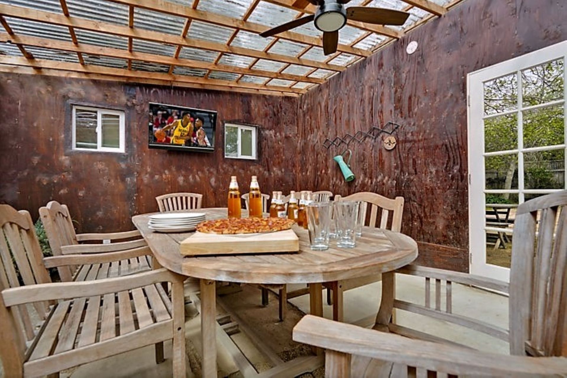 A patio with a table and chairs and bottles on it