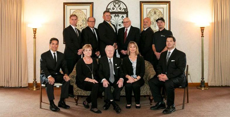 A group of people are posing for a picture in a room.