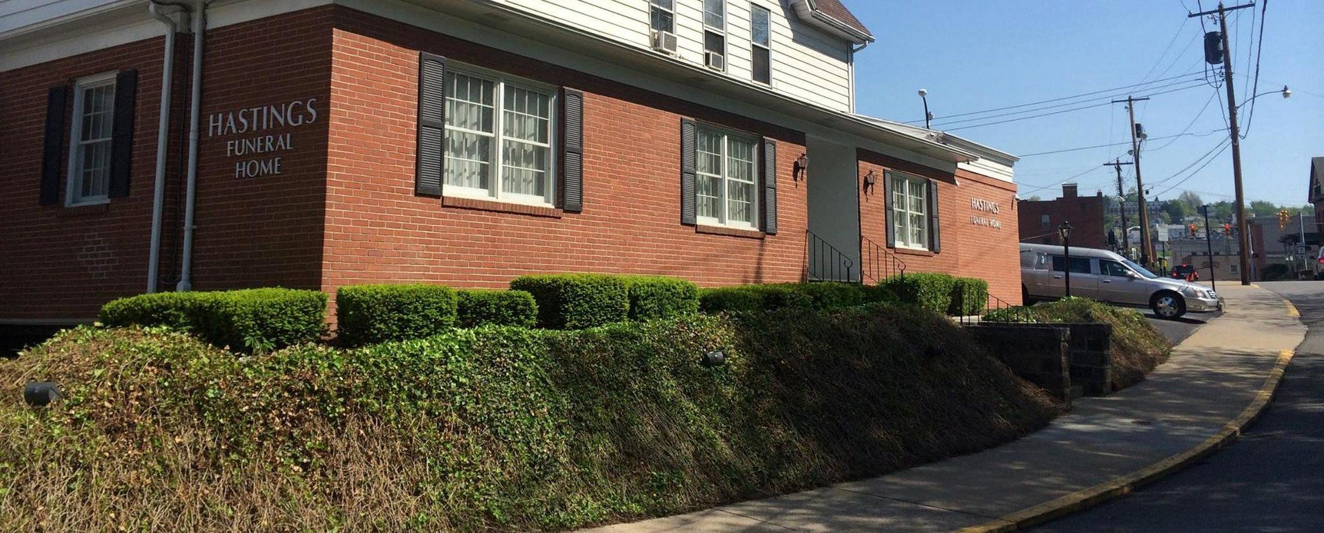 A brick building with a lot of bushes in front of it.
