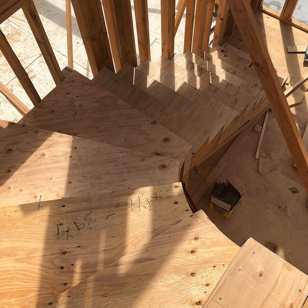 Wooden spiral staircase under construction.