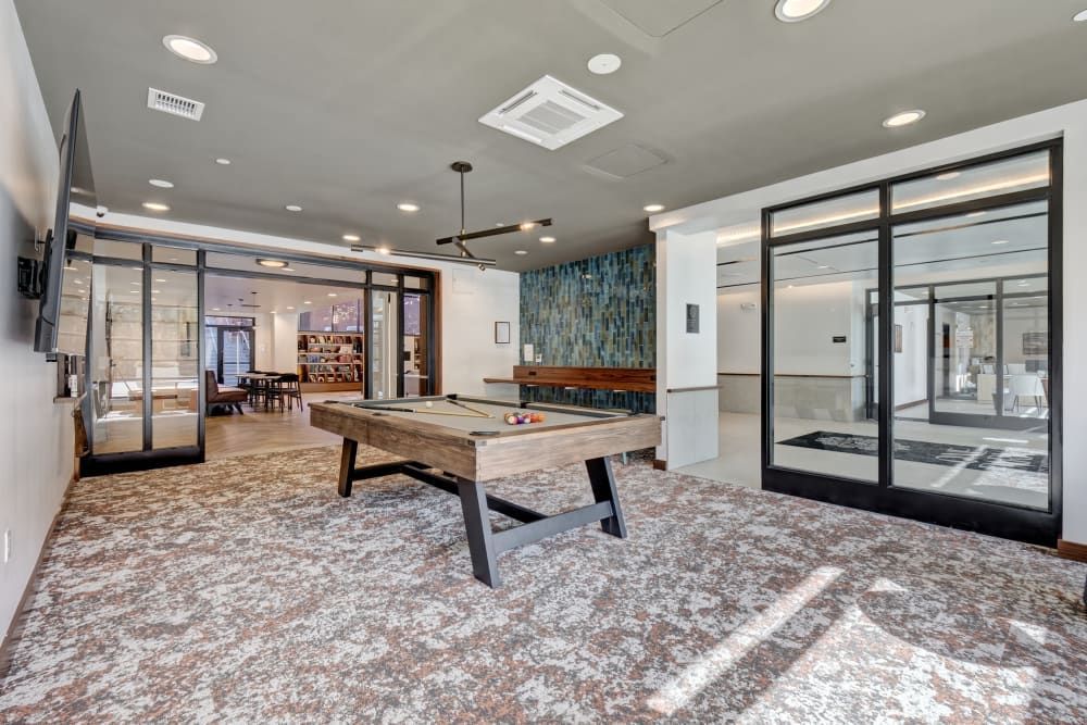 There is a pool table in the middle of the room.