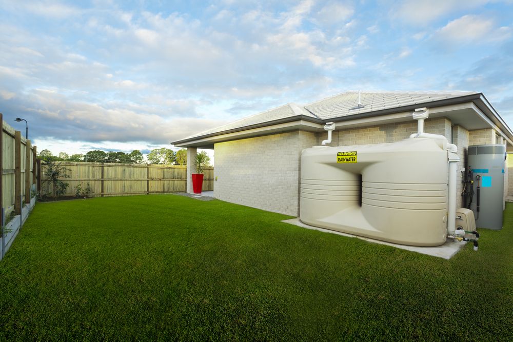 A House With a Large Water Tank in the Backyard — Absolute Plumbing Australia in Howard Spring, NT