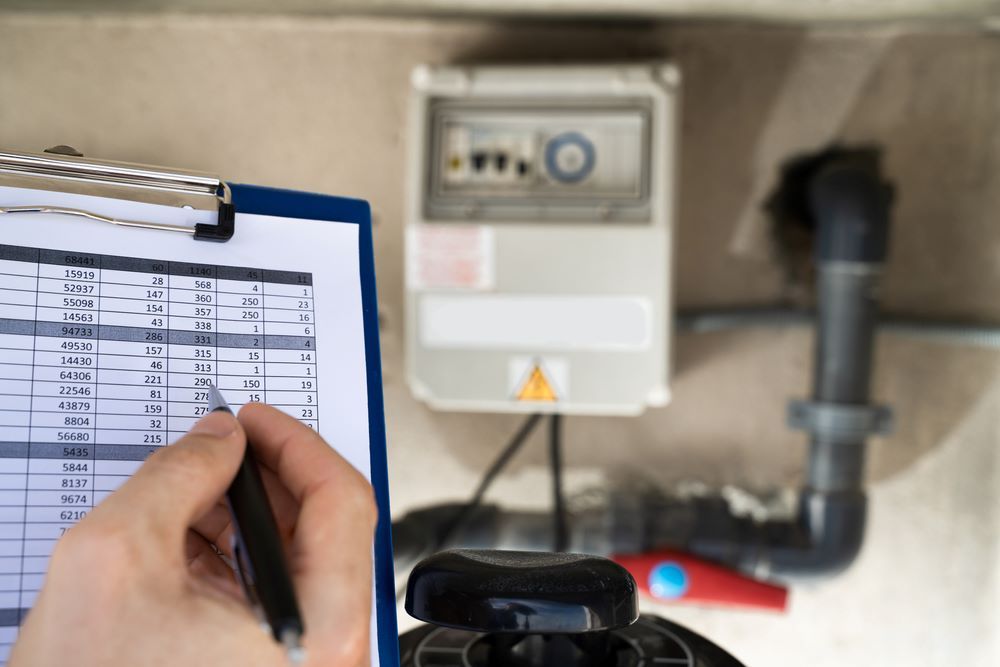 A Person is Writing on a Clipboard With a Pen — Absolute Plumbing Australia in Darwin Region, NT
