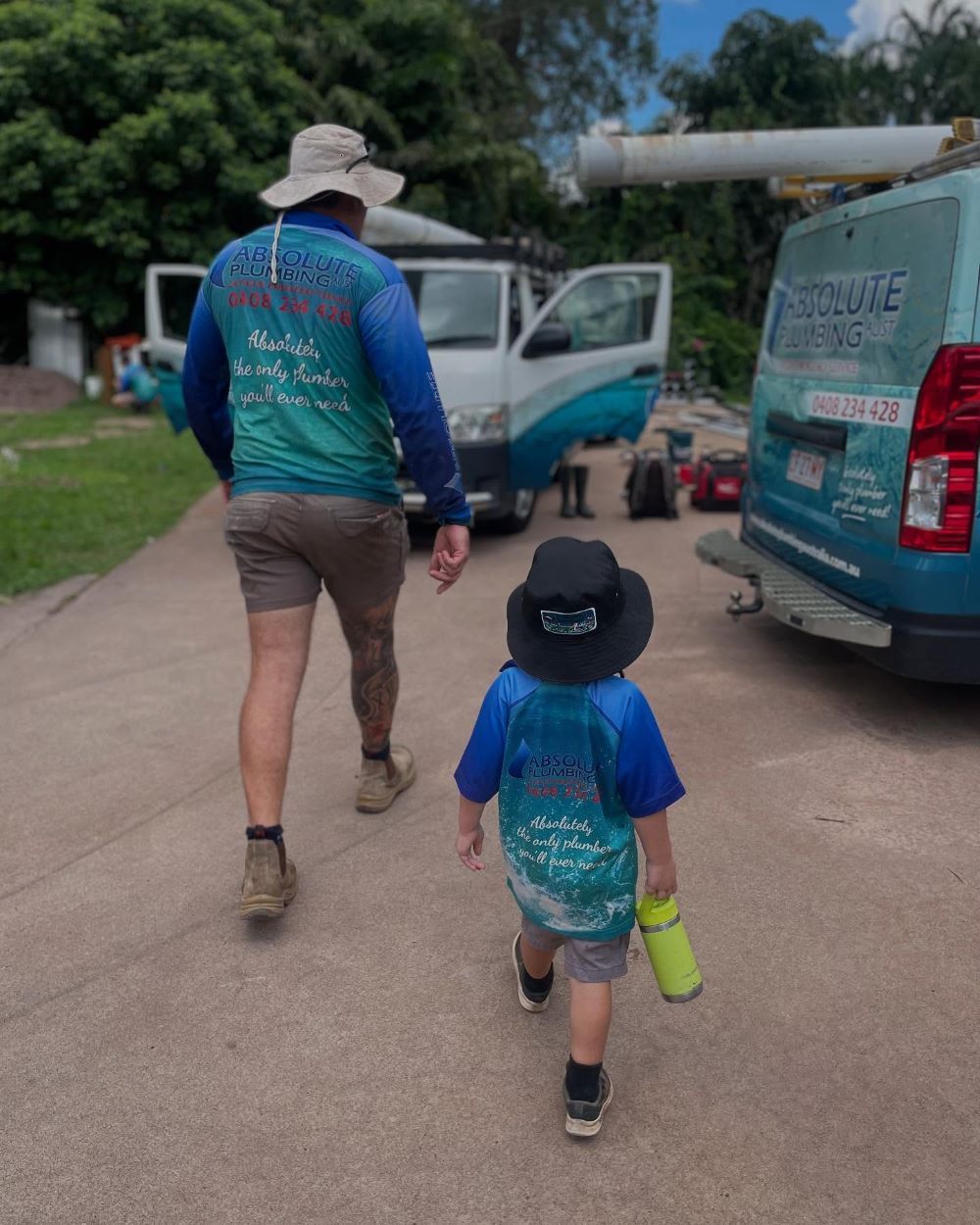 A Man and a Child Walking To Work Ute — Absolute Plumbing Australia in Howard Spring, NT