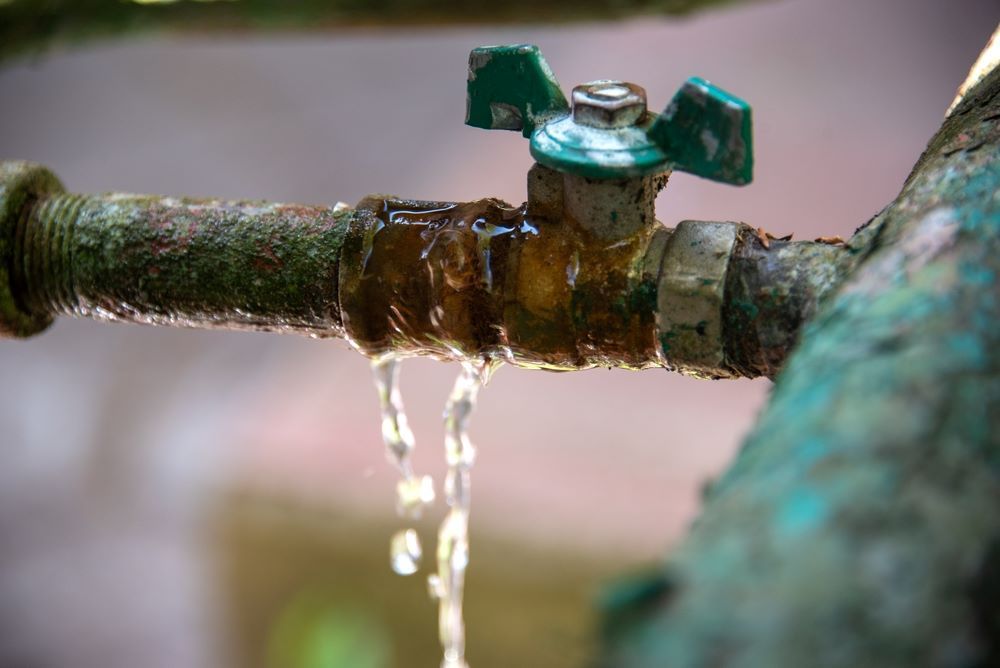 A Close Up of a Faucet With Water Leaking Out of It — Absolute Plumbing Australia in Palmerston, NT