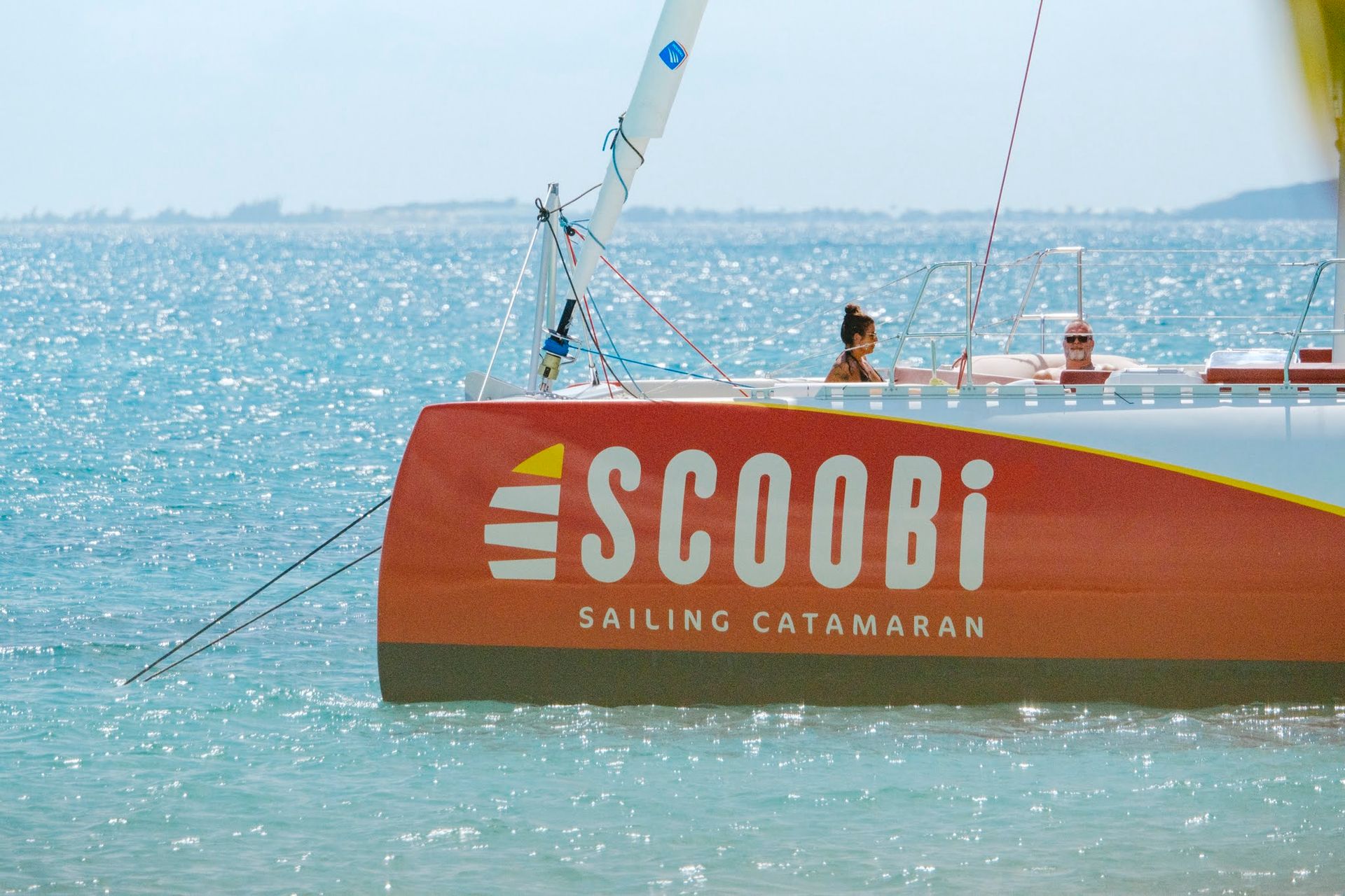 Orange and white catamaran 