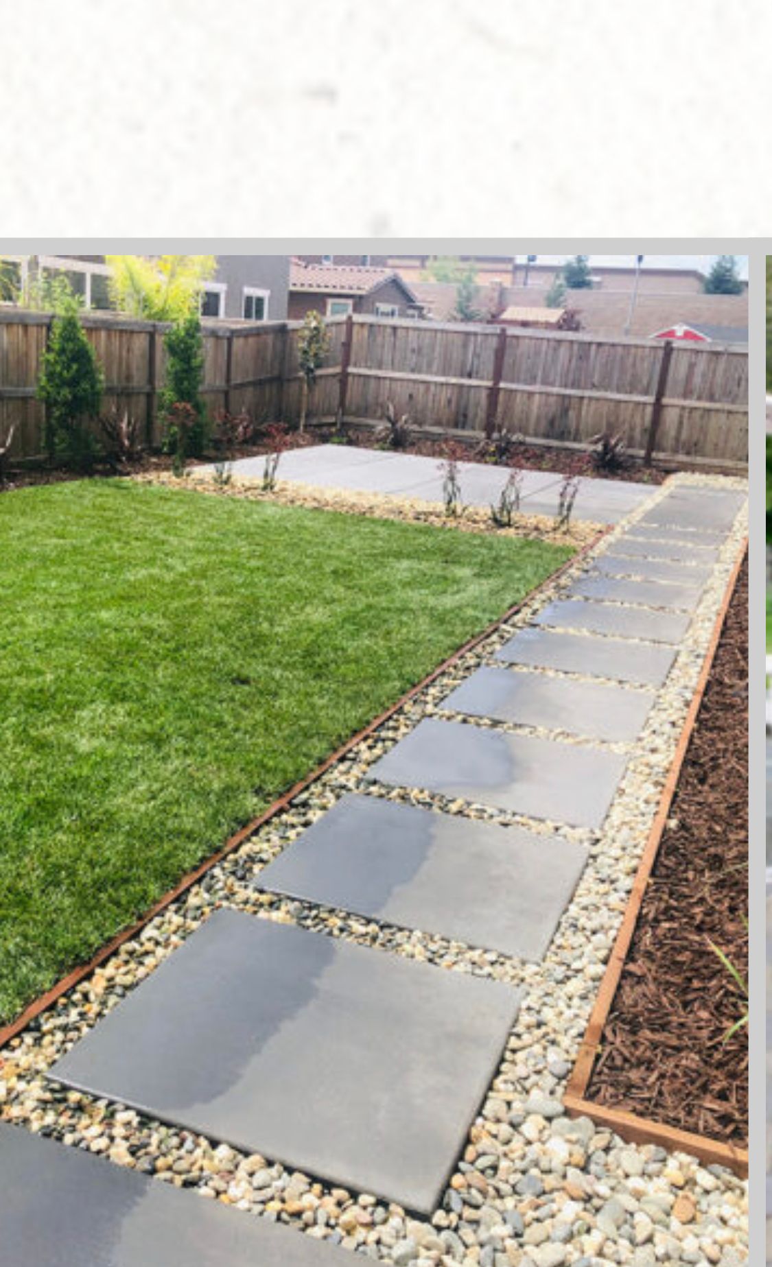 Backyard patio path with large gray stepping stones, gravel borders, green lawn, and wooden fence