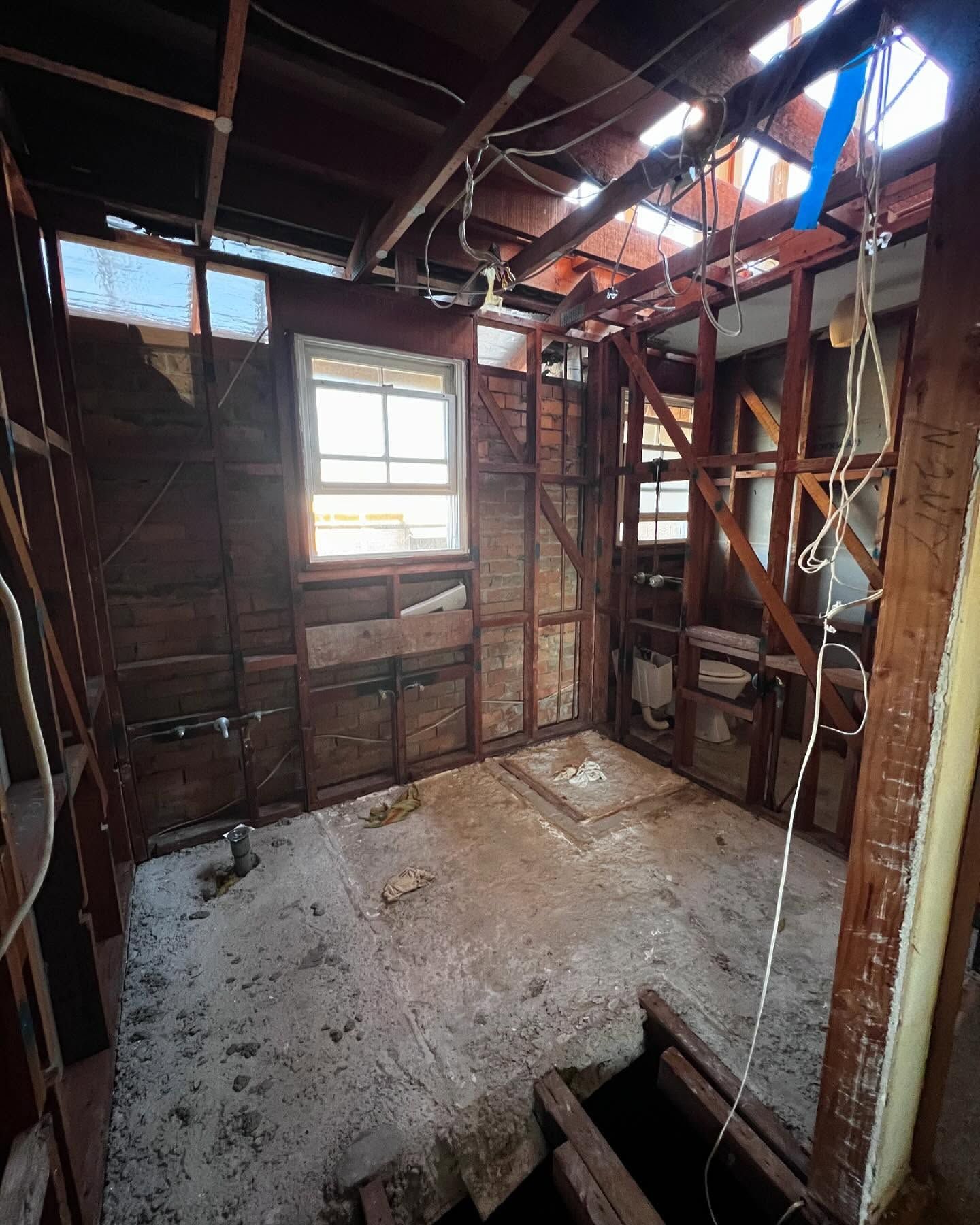 Interior of a Room Under Construction, With Exposed Wooden Studs — Ecowave Solutions Asbestos Removal In Gosford, NSW
