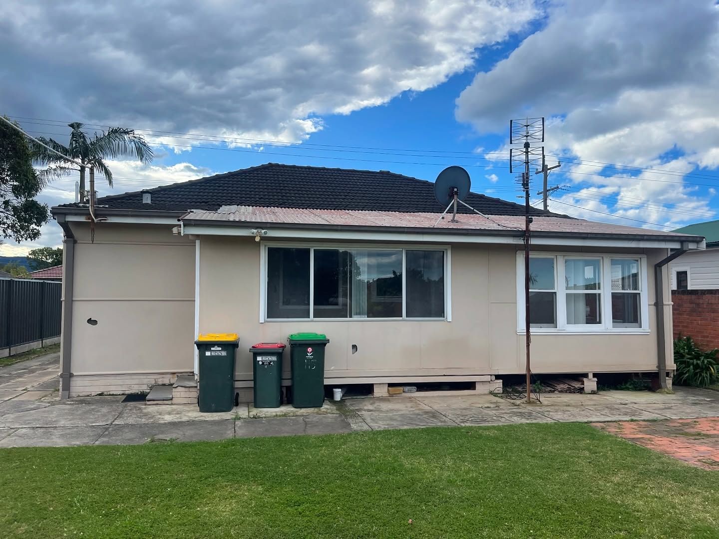 Backyard View of a Beige House With a Dark Roof — Ecowave Solutions Asbestos Removal In Gosford, NSW