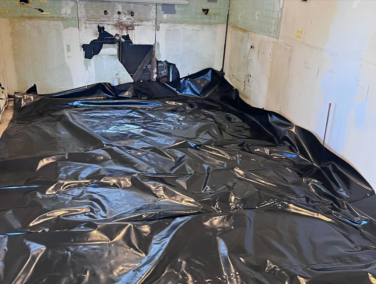Room With Walls and Floor Covered in Black Plastic Sheeting — Ecowave Solutions Asbestos Removal In Gosford, NSW