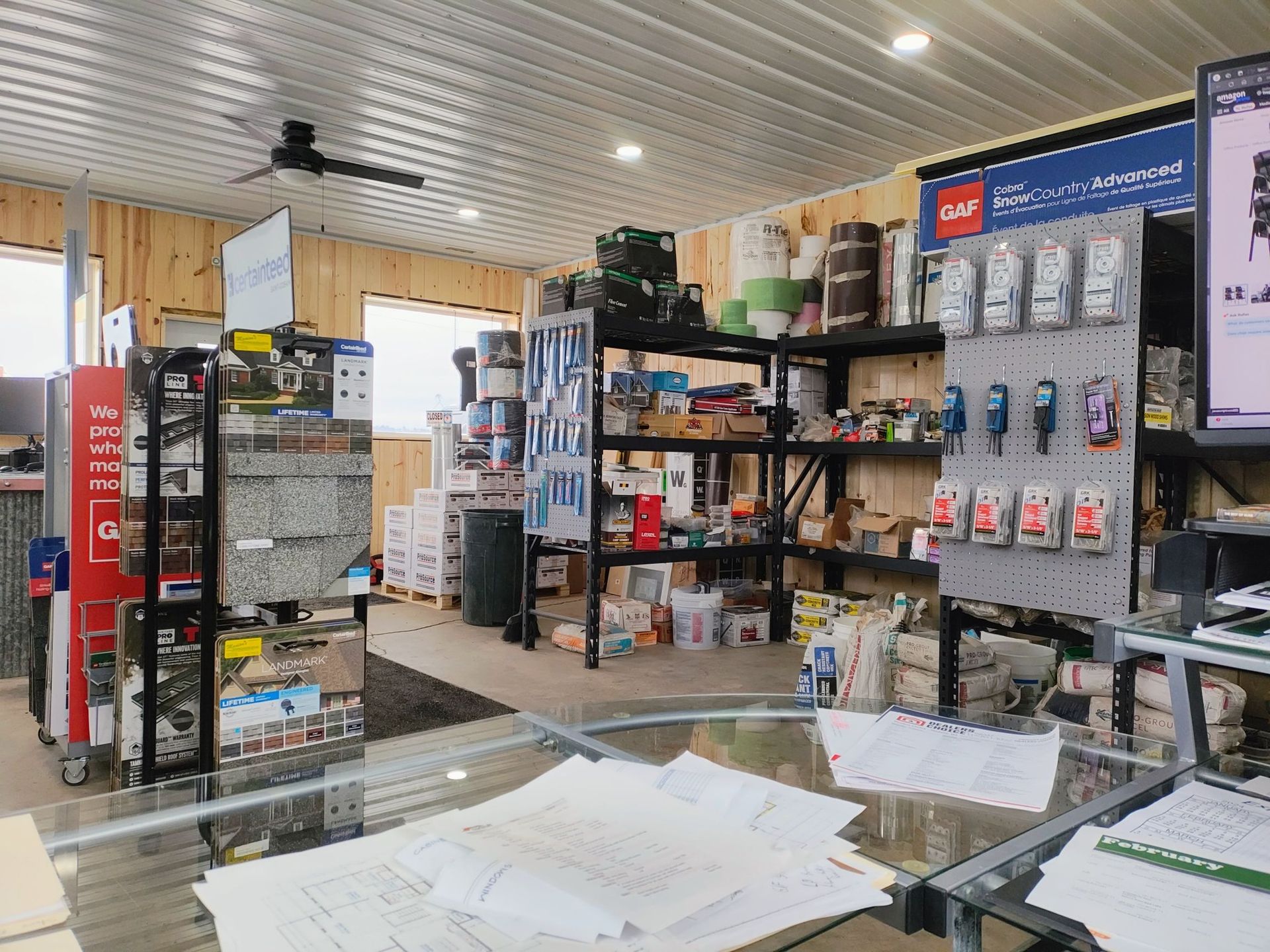 A store filled with lots of supplies and a table with papers on it.
