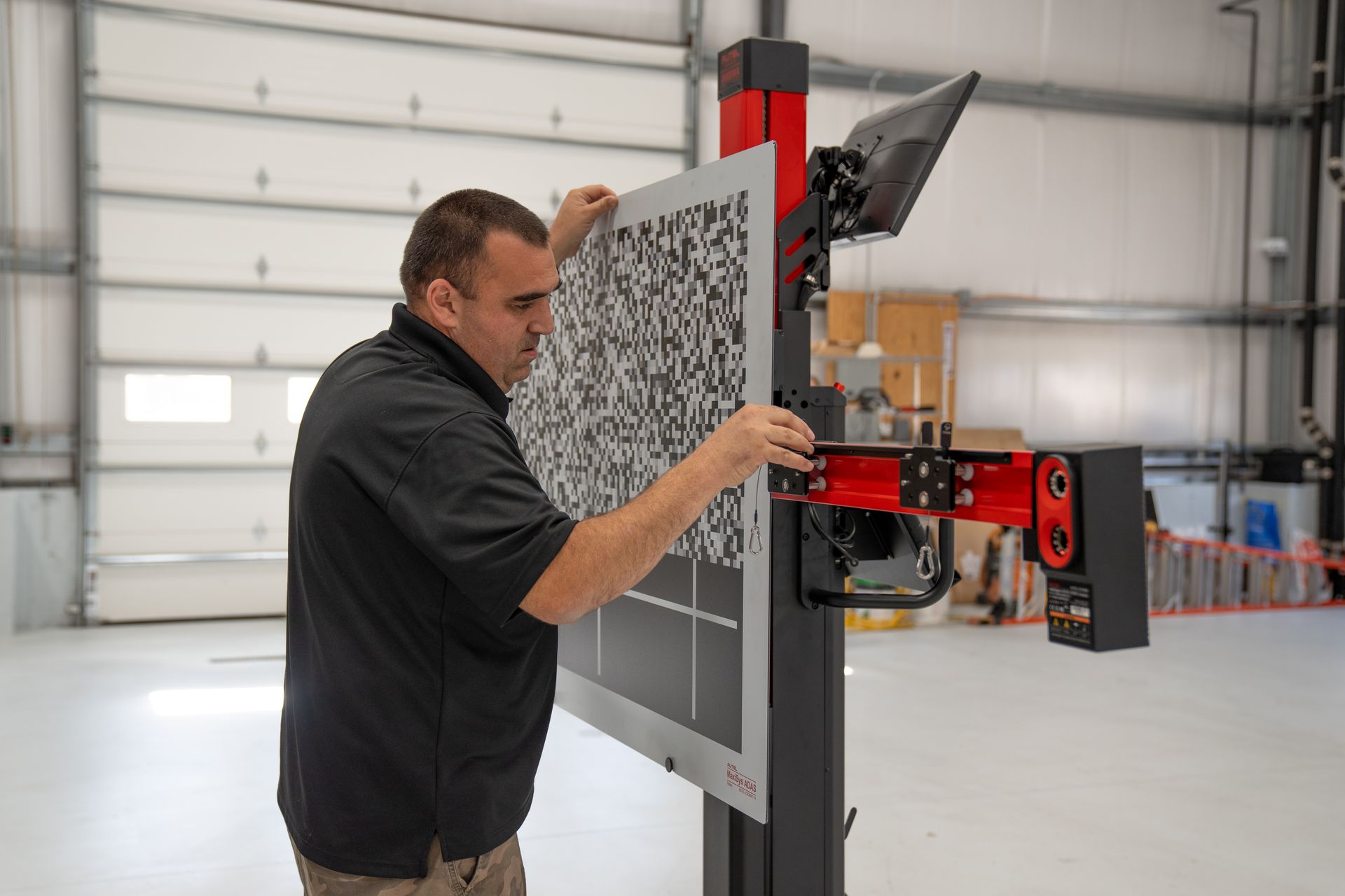 A man is working on a machine in a garage.