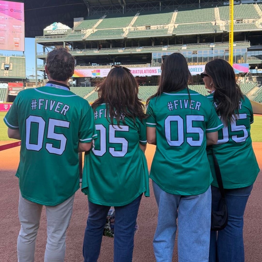 A group of people wearing black shirts with the number 5 on them