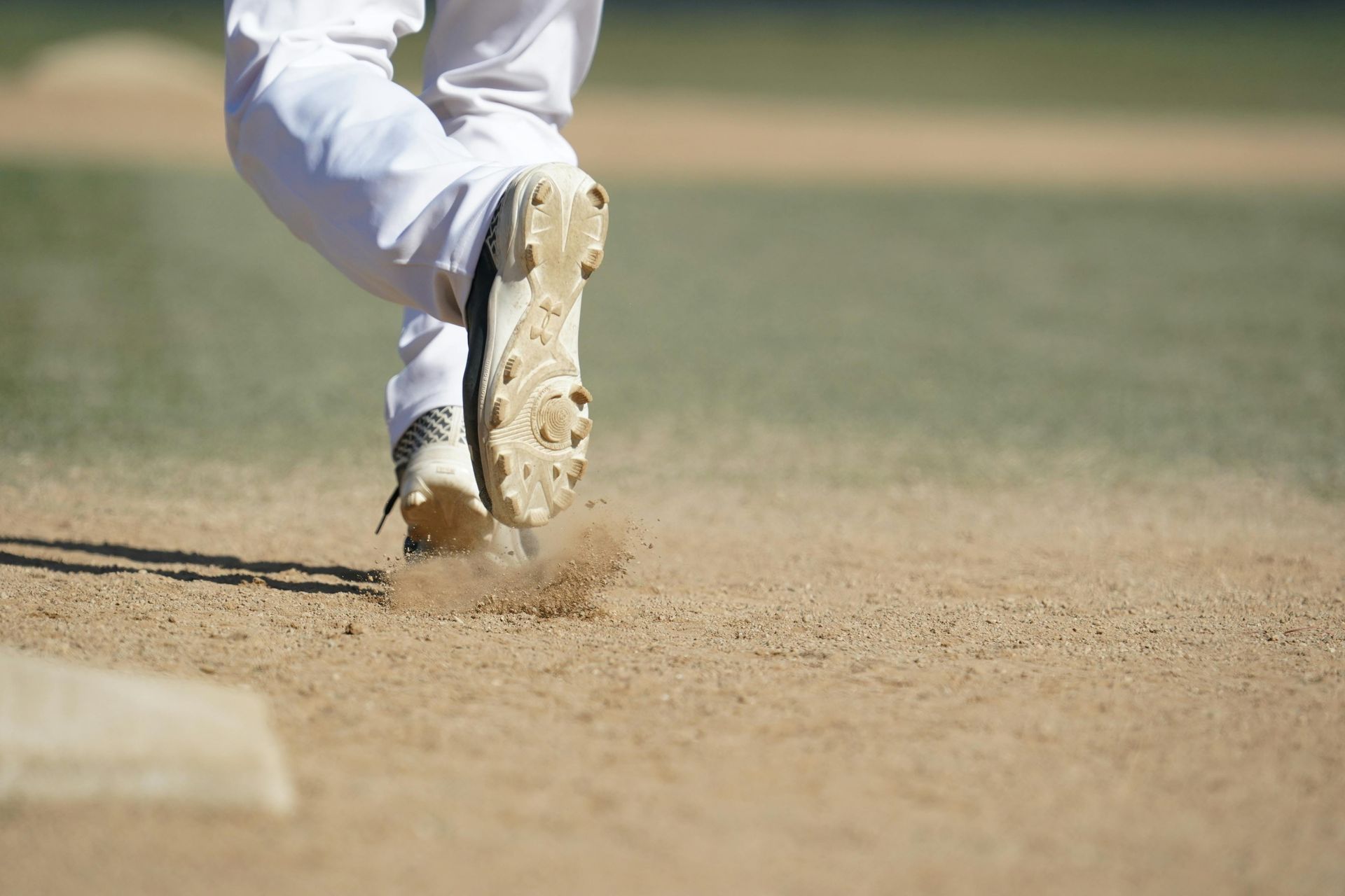 Baseball on a dark surface, with visible stitching.