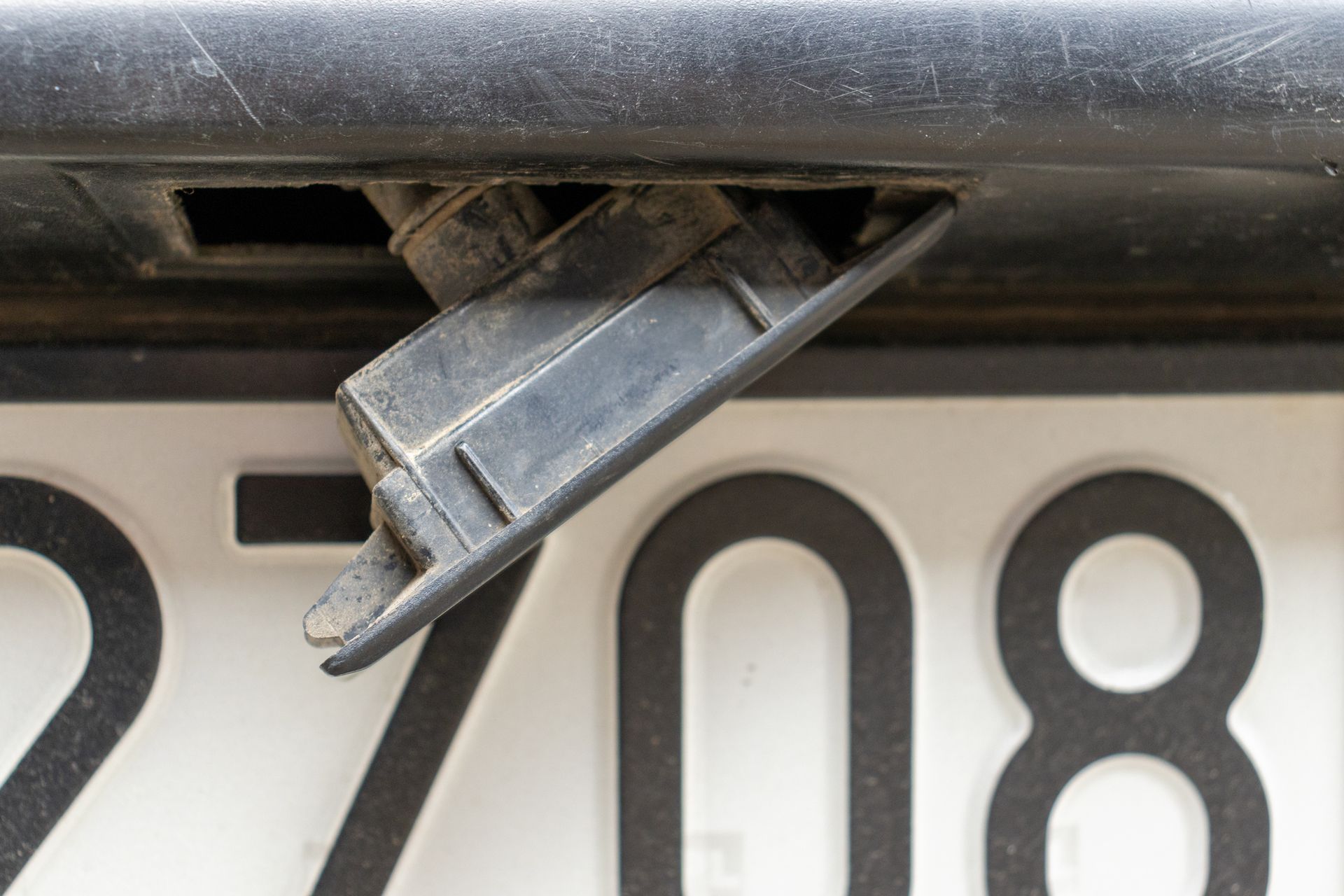A close up of a license plate on a car. A close up of a license plate on a car.