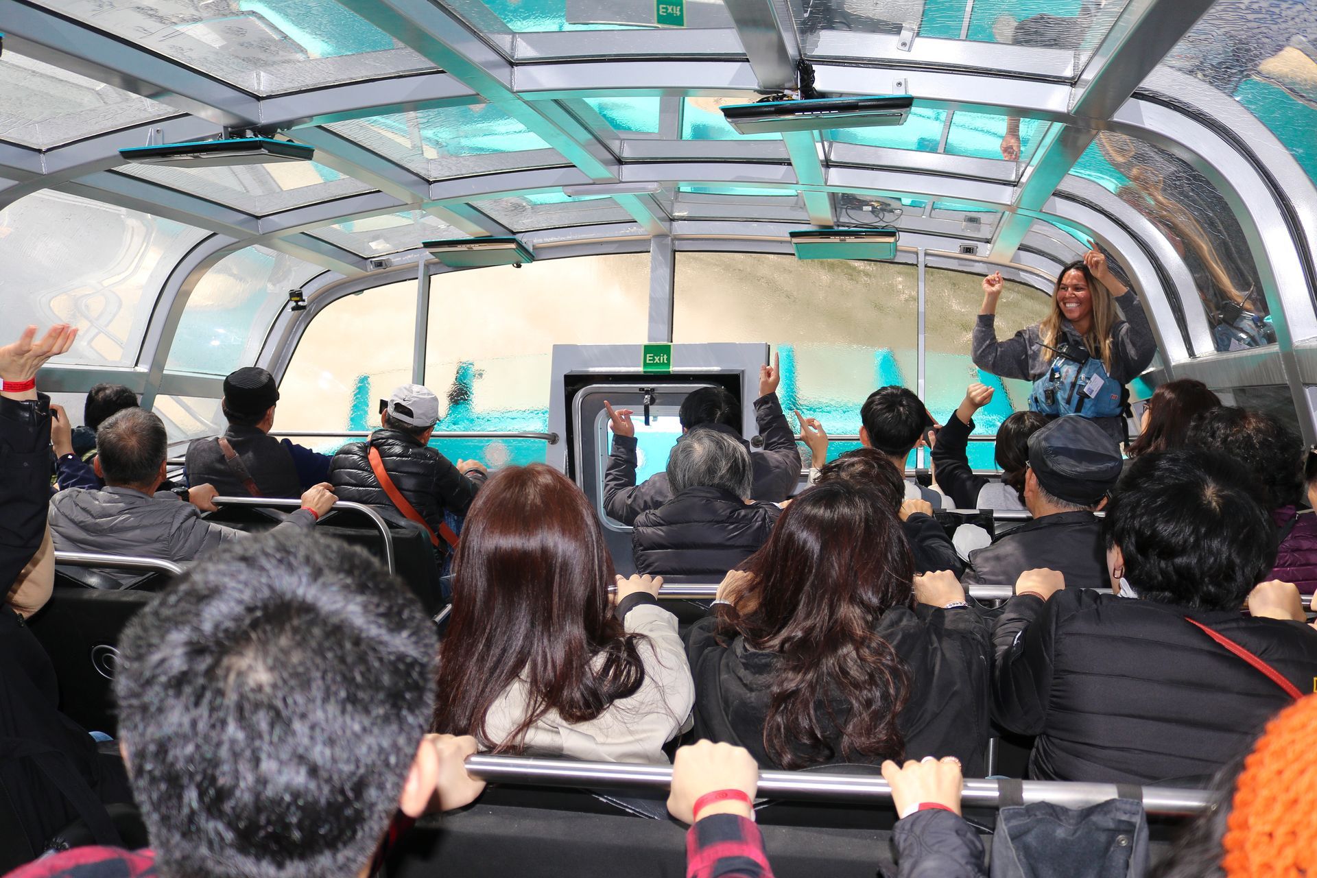 Guests ride beneath the Freedom Jet’s enclosed glass canopy while a guide leads the experience.