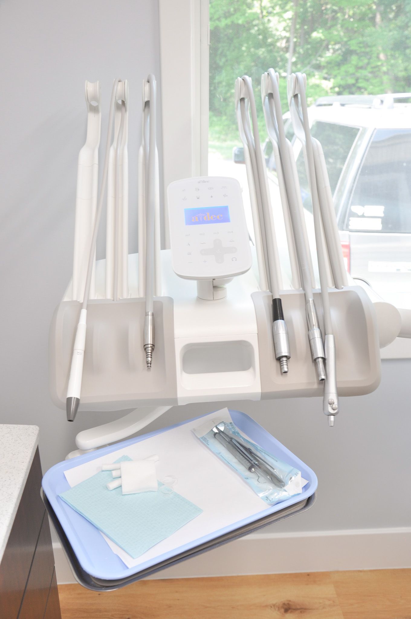 Dental equipment with tray of sterile supplies next to a window.