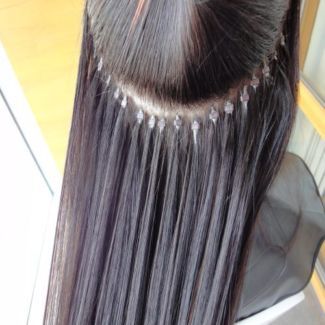 A close up of a woman 's hair with extensions.