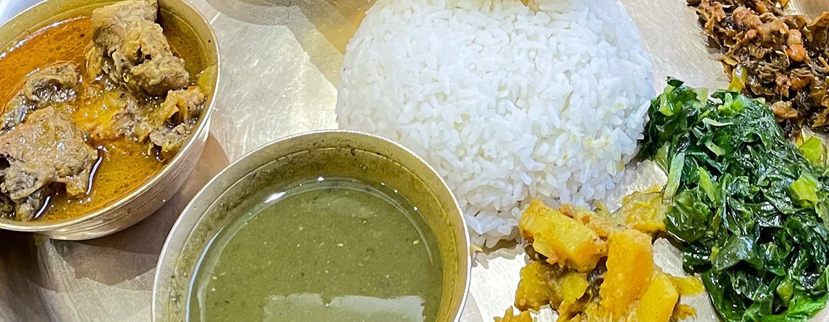 Nepali cuisine served during a trek, featuring rice, vegetables, and traditional dishes enjoyed in nature.