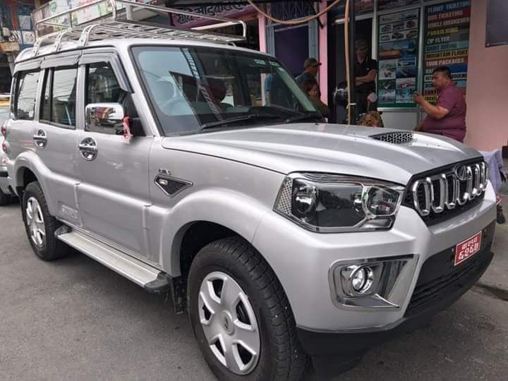 Silver jeep parked on a roadside, representing private transport options available for travel from Kathmandu to Pokhara.