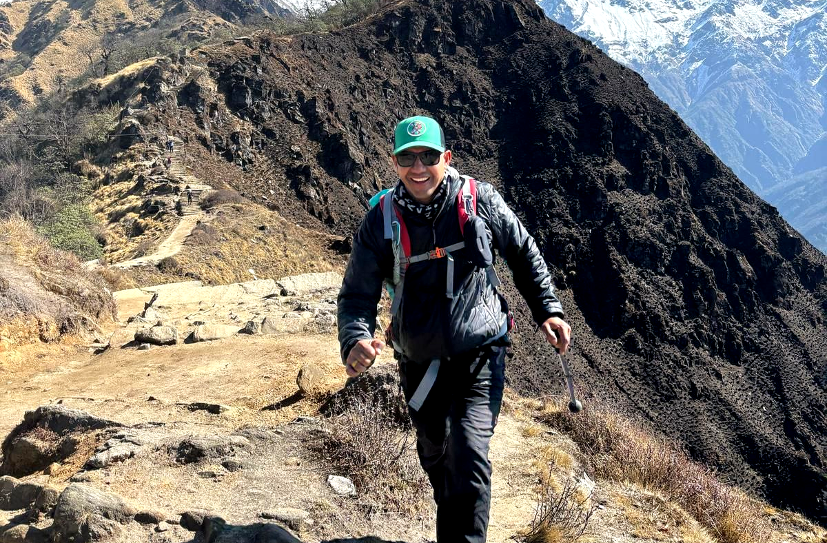 Trekking guide hiking on a mountain trail in the Annapurna region, Nepal
