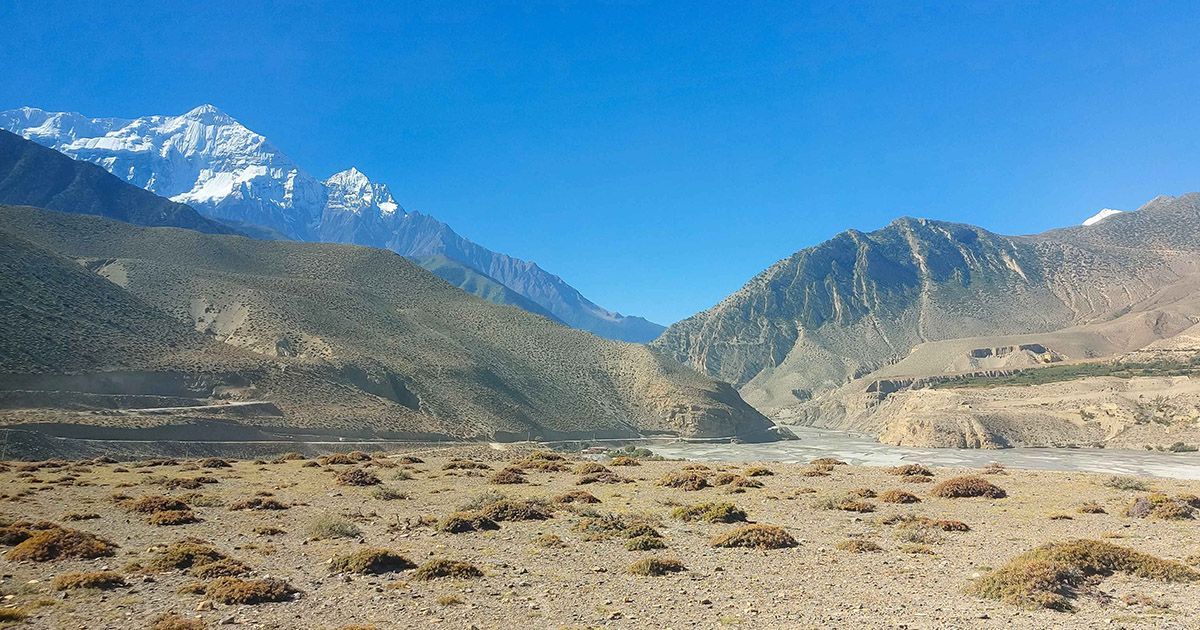 Breathtaking landscapes with Himalayan peaks along the Lower Mustang Trek in Nepal, showcasing unique desert-like terrain.