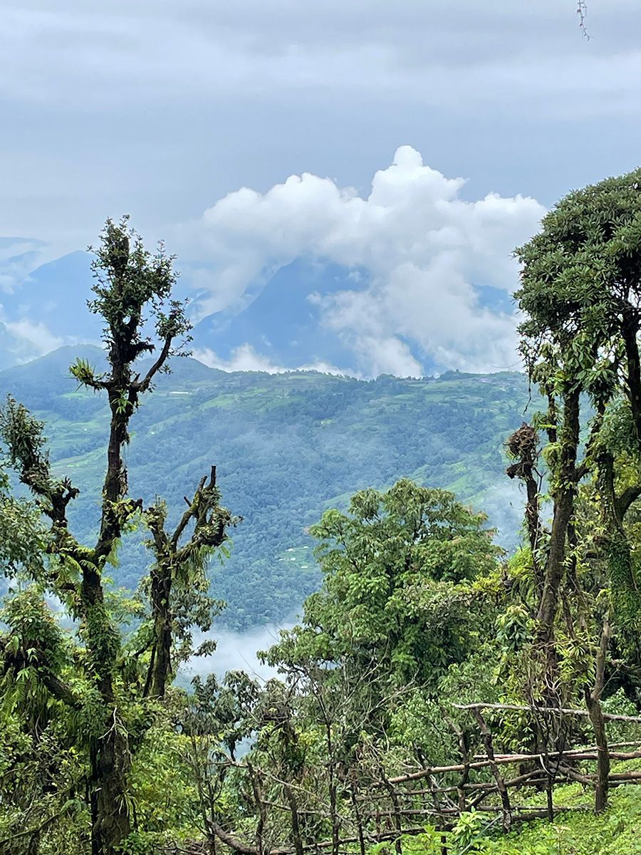 Majestic mountains shrouded in clouds, highlighting the breathtaking views along Nepal trekking routes.