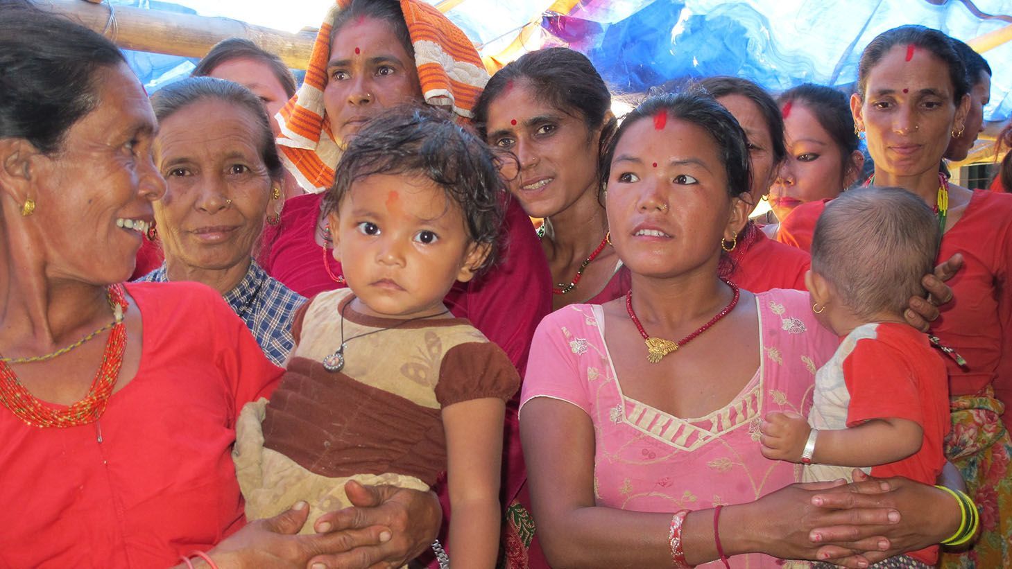 Group of Nepali women and children in traditional attire, celebrating together during a cultural event in Nepal.