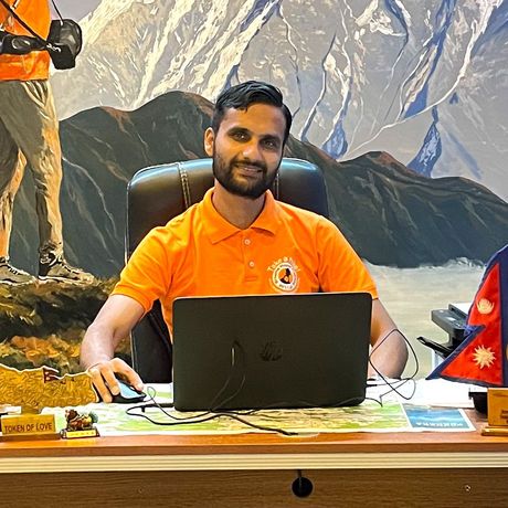 Local trekking guide in his office in Pokhara, Nepal, ready to assist adventurers on their journeys.