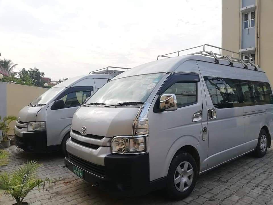 Two vans parked side by side, representing another transport option for traveling from Kathmandu to Pokhara in Nepal.