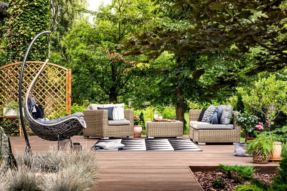 Outdoor Patio With Wicker Furniture, Hanging Chair, Wooden Patios — Kalora Carpentry & Restorations in Charlestown, NSW