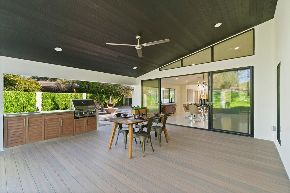 Patio With Outdoor Kitchen, Dining Table — Kalora Carpentry & Restorations in New Lambton, NSW
