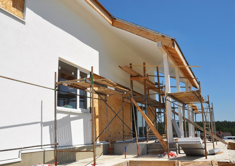 Construction of a White Building With Scaffolding in Front of Windows — Kalora Carpentry & Restorations in Charlestown, NSW