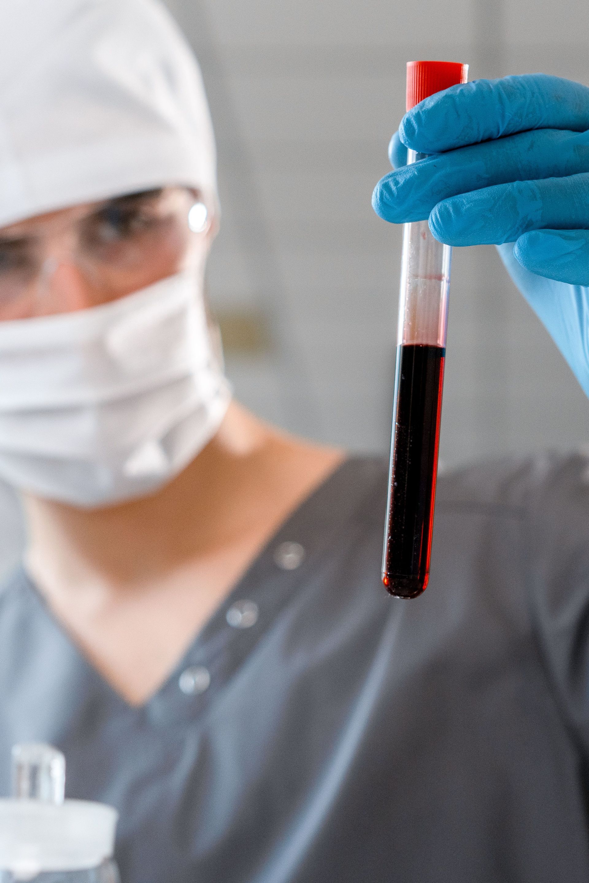 Dr looking at a vial of blood