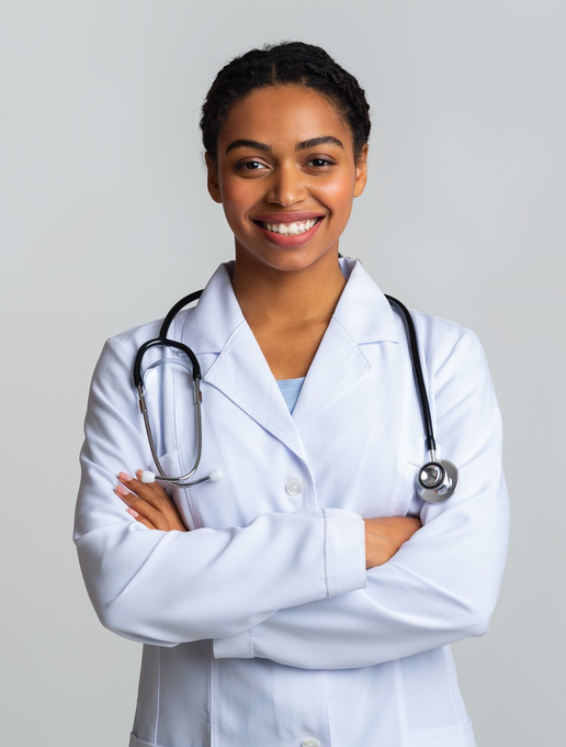 Smiling doctor in a white coat with a stethoscope, standing with arms crossed against a gray background