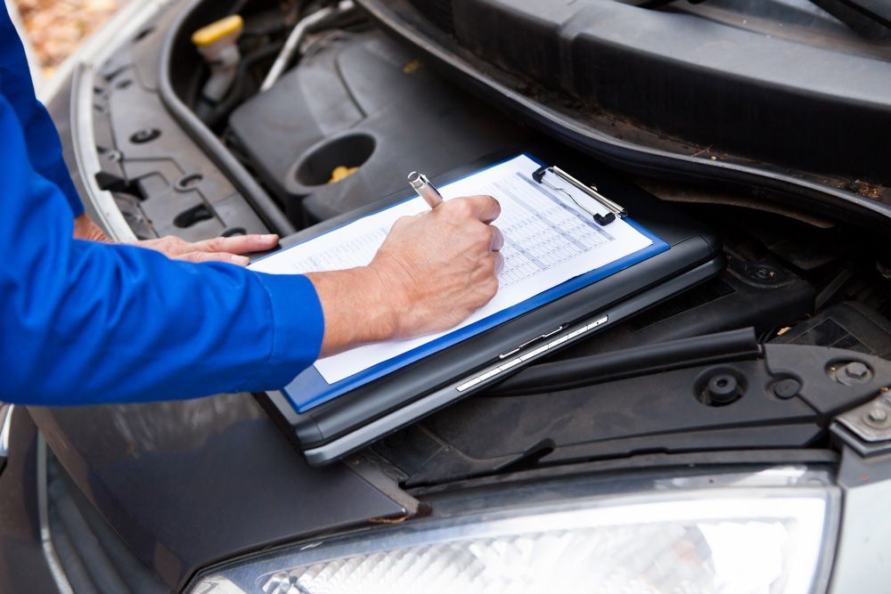 Mechanic Maintaining Car Records — Crossway Wreckers & Mechanical In Gordonvale, QLD