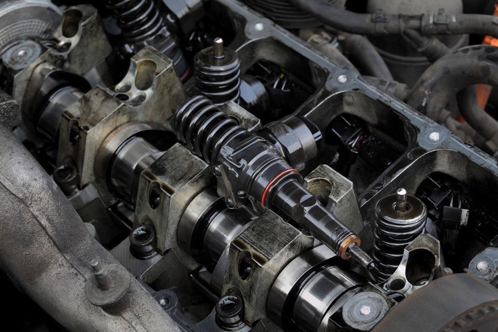 Closeup Of Injectors In Cylinder Head With Camshaft — Crossway Wreckers & Mechanical In Cairns, QLD