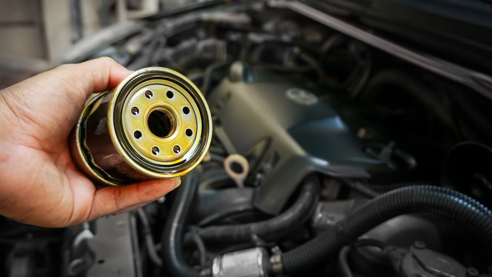 Hands Of Mechanic Doing Car Service And Maintenance — Crossway Wreckers & Mechanical In Gordonvale, QLD