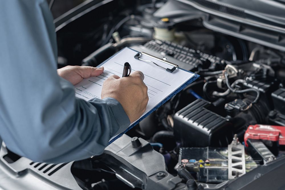 Close Up Hand Car Service Staff Check The Engine — Crossway Wreckers & Mechanical In Gordonvale, QLD