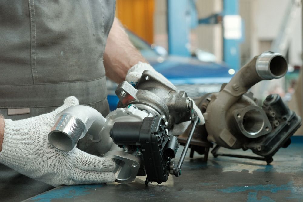 Auto Mechanic Monitors And Checks The Spare Part Before Replacing It On The Engine — Crossway Wreckers & Mechanical In Gordonvale, QLD