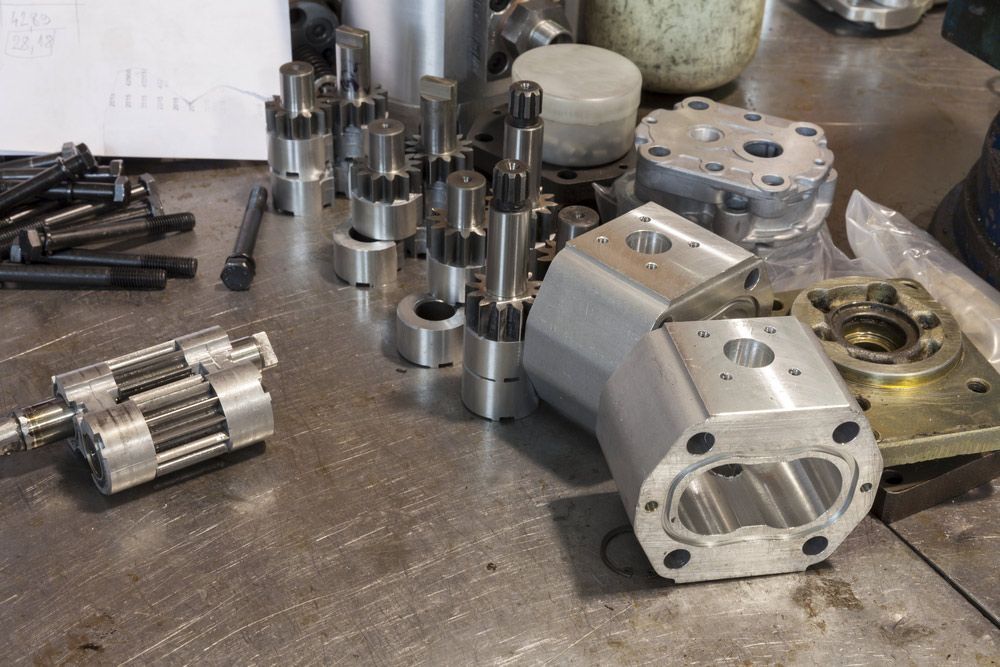 A Bunch Of Metal Parts Are Sitting On A Table — Crossway Wreckers & Mechanical In Gordonvale, QLD