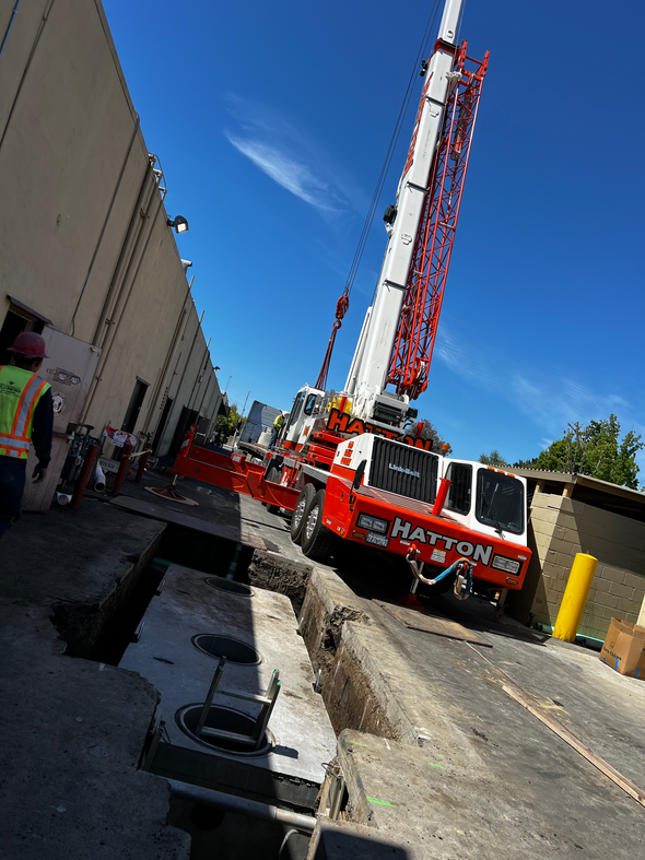 Installing equipment using a large crane near a commercial building